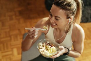 Mulher comendo após aula de pilates.